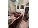 Bathroom with granite countertops, dual sinks with decorative bowls, and elegant fixtures at 716 Bethpage Dr, Mcdonough, GA 30253