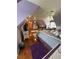 Slanted ceiling bedroom features a queen bed, wood floors and ceiling fan at 716 Bethpage Dr, Mcdonough, GA 30253