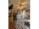 Cozy bedroom featuring a queen bed, wood floors, ceiling fan, and unique zebra rug at 716 Bethpage Dr, Mcdonough, GA 30253