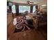 Spacious bedroom featuring a sitting area, ceiling fan, large windows, and hardwood floors at 716 Bethpage Dr, Mcdonough, GA 30253