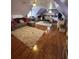 Spacious bedroom with wood floors, a queen bed, ceiling fan, and plush seating at 716 Bethpage Dr, Mcdonough, GA 30253