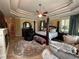 Bedroom featuring a sitting area, ceiling fan, large windows with shutter and a tray ceiling at 716 Bethpage Dr, Mcdonough, GA 30253