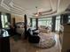 Bedroom featuring a sitting area, ceiling fan, large windows with shutter and a tray ceiling at 716 Bethpage Dr, Mcdonough, GA 30253