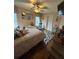 Bedroom with queen bed, decorative mirrors, wood floors and ceiling fan offers cozy retreat at 716 Bethpage Dr, Mcdonough, GA 30253