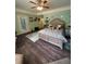 Cozy bedroom features a stylish ceiling fan, hardwood floors, and an ornate upholstered headboard for a luxurious feel at 716 Bethpage Dr, Mcdonough, GA 30253