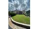 Beautifully landscaped front yard with mature trees and shrubs leading up to a grand home at 716 Bethpage Dr, Mcdonough, GA 30253