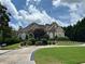 Stunning two-story home featuring a well-manicured lawn, circular driveway, and beautiful landscaping at 716 Bethpage Dr, Mcdonough, GA 30253