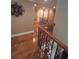 Upstairs hallway featuring hardwood floors, decorative wrought iron railings, and many rooms at 716 Bethpage Dr, Mcdonough, GA 30253