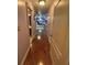 A long hallway leads to a bedroom with multiple beds, ceiling fans and plush carpet at 716 Bethpage Dr, Mcdonough, GA 30253