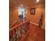 Second story hallway with beautiful wood floors and wrought iron railing provides access to multiple rooms at 716 Bethpage Dr, Mcdonough, GA 30253