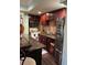 A cozy kitchen featuring wood cabinets, granite counters, stainless steel appliances, and a tile backsplash at 716 Bethpage Dr, Mcdonough, GA 30253
