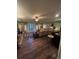 Spacious living room with hardwood floors, ceiling fan, French doors, a bar, and comfortable seating at 716 Bethpage Dr, Mcdonough, GA 30253