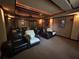 Home media room with tiered seating and ambient ceiling lighting perfect for movie nights at 716 Bethpage Dr, Mcdonough, GA 30253