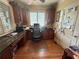 Inviting office space with a large desk, wooden cabinets, and natural light from the shuttered window at 716 Bethpage Dr, Mcdonough, GA 30253
