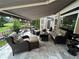 Beautiful patio with wicker seating, a retractable awning, elegant landscaping, and scenic views at 716 Bethpage Dr, Mcdonough, GA 30253