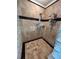 Tiled shower with dual shower heads and glass block wall, featuring a neutral color palette at 716 Bethpage Dr, Mcdonough, GA 30253
