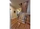 Elegant staircase featuring hardwood floors, decorative wrought iron railings, and natural light at 716 Bethpage Dr, Mcdonough, GA 30253