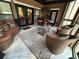 Spacious sunroom with a bar, comfortable seating, and a view through many windows at 716 Bethpage Dr, Mcdonough, GA 30253