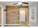 Hallway with wood plank accent wall and modern light fixtures at 118 Hunters Pl, Villa Rica, GA 30180