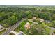 Aerial view shows charming home nestled in a lush, green neighborhood with mature trees and well-maintained lawns at 3623 Doroco Dr, Atlanta, GA 30340
