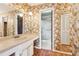 Bright bathroom with wallpaper, vanity, and a mirror, plus a view into the shower at 3623 Doroco Dr, Atlanta, GA 30340