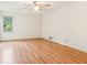 Large bedroom with hardwood floors, white walls, a ceiling fan, and a window at 3623 Doroco Dr, Atlanta, GA 30340