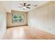 Bright bedroom featuring ceiling fan, light walls, and wood floors at 3623 Doroco Dr, Atlanta, GA 30340