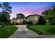 Charming two-story home with a stone facade under a vivid twilight sky and landscaped yard at 3623 Doroco Dr, Atlanta, GA 30340