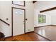 Bright foyer featuring hardwood floors, a white front door with glass, and adjacent living spaces at 3623 Doroco Dr, Atlanta, GA 30340