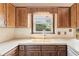 Kitchen sink with wood cabinets and a window looking out to greenery at 3623 Doroco Dr, Atlanta, GA 30340