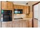 Kitchen featuring wood cabinets and black appliances at 3623 Doroco Dr, Atlanta, GA 30340