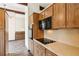 Galley kitchen with wood cabinets and black appliances at 3623 Doroco Dr, Atlanta, GA 30340