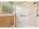 Bathroom shower with glass door, a window, neutral-toned wall and chrome fixtures at 3623 Doroco Dr, Atlanta, GA 30340
