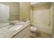 Bathroom featuring tiled floors, granite counters, and a shower-tub combo at 5958 Tate Dr, Austell, GA 30106