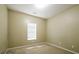 Bedroom with beige carpet and walls, featuring a window for natural light at 5958 Tate Dr, Austell, GA 30106