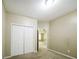 Bedroom with neutral walls, carpet, bi-fold closet doors, and entry view to a nearby room at 5958 Tate Dr, Austell, GA 30106
