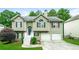 Charming two-story home with a manicured lawn and two-car garage at 5958 Tate Dr, Austell, GA 30106