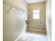Compact laundry room with tile flooring and a window for natural light at 5958 Tate Dr, Austell, GA 30106