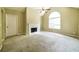 Bright living room featuring a fireplace, vaulted ceiling, and large arched window at 5958 Tate Dr, Austell, GA 30106
