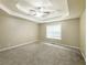 Large carpeted main bedroom featuring a tray ceiling and lots of natural light at 5958 Tate Dr, Austell, GA 30106