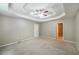Large carpeted main bedroom featuring a tray ceiling and ensuite access at 5958 Tate Dr, Austell, GA 30106