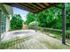 Image shows the concrete patio with a lush, green backyard and mature trees at 5958 Tate Dr, Austell, GA 30106