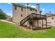 Spacious backyard features a deck, stairs, stone accents, and lush greenery at 871 Windsor Creek Dr, Grayson, GA 30017