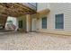 View of the backyard patio, stairs, and foundation with two windows and a door at 871 Windsor Creek Dr, Grayson, GA 30017