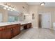 Bathroom featuring dual sinks, a walk-in closet, and tile flooring for a modern look at 871 Windsor Creek Dr, Grayson, GA 30017