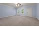 Spacious blue bedroom featuring a ceiling fan and natural light through the windows at 871 Windsor Creek Dr, Grayson, GA 30017
