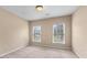 Neutral bedroom featuring two windows bringing in natural light, and neutral carpet at 871 Windsor Creek Dr, Grayson, GA 30017