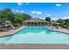 Community pool area with pool house, lounge chairs, tables, and lush landscaping at 871 Windsor Creek Dr, Grayson, GA 30017