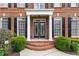 Charming front entrance with brick steps, columns, and a decorative glass door at 871 Windsor Creek Dr, Grayson, GA 30017