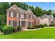 Beautiful red brick home with black shutters and landscaped front yard at 871 Windsor Creek Dr, Grayson, GA 30017